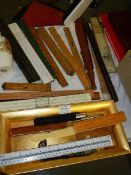 A mixed lot of wooden and other rulers.