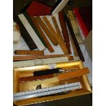 A mixed lot of wooden and other rulers.