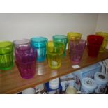 A quantity of coloured glass tumblers.