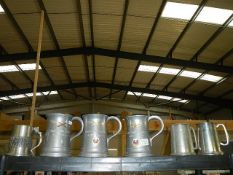 Six metal tankards.