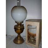 An oil lamp and a boxed table lamp.