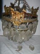 A small old chandelier featuring cherubs. ****Condition report**** Missing droppers.