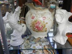 A large jug, a white horse figure and one other item.