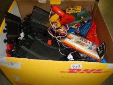 A box of scalextric items.