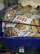 A large box of loose postage stamps.