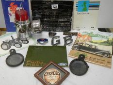 A mixed lot of motoring items including badges, tax disc, books etc.