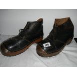 A pair of old steel toecap boots.
