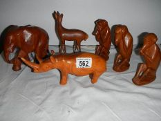 A quantity of wooden animals including three wise monkey's, rhino etc.