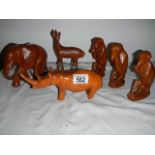 A quantity of wooden animals including three wise monkey's, rhino etc.