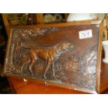 A wall plaque featuring a hunting hound.