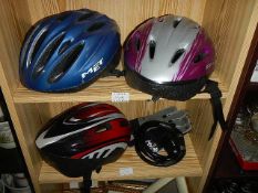 Three cycle helmets, a cycle chain and gloves.