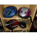 Three cycle helmets, a cycle chain and gloves.