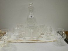 A cut glass decanter and assorted glasses.