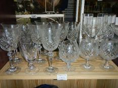 A quantity of drinking glasses including brandy, champagne flutes etc.