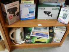 Two shelves of assorted household items including CCTV camera's.