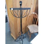 A wrought iron plant stand and a wall mounting plant stand.