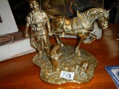 A brass horse with farrier.