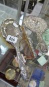 A silver backed mirror, brush and comb.