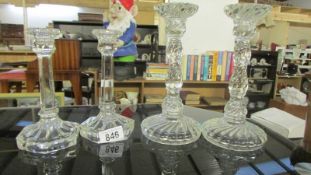 Two pairs of glass candlesticks.