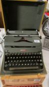 A cased vintage Hermes 2000 typewriter.
