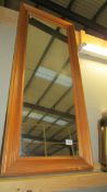 A tall pine framed mirror.