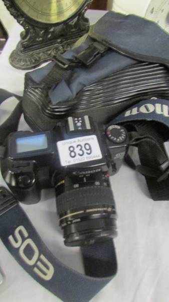 A Canon EOS 1000F camera in case.