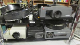 A Kodak slide projector and three others.