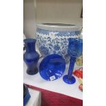 A blue glass vase, blue glass bowl and blue glass candleholder.
