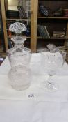 A cut and engraved glass decanter (chip to base) and a cut and engraved glass goblet.