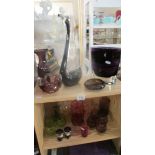 Two shelves of art glass, drinking glasses etc., including cranberry.