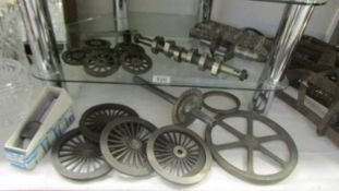 A quantity of cast iron 4" gauge line steam loco wheels and other items.