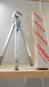 A boxed good quality camera tripod.