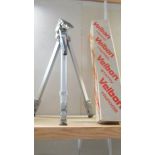 A boxed good quality camera tripod.