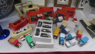 A mixed lot of die cast trade vans, cars etc.