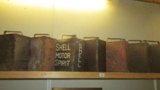 Seven 1920's two gallon petrol cans including Pratt's, Shell etc., (only one has cap).
