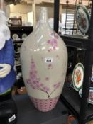 A tall pink Chinese style vase