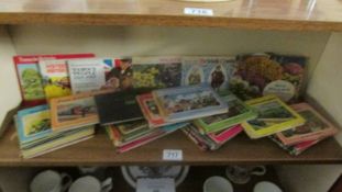 Approximately 24 early Thomas The Tank Engine books and six books of tea cards.