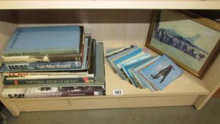 A quantity of books and postcards related to aircraft.