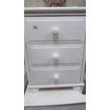 A white three drawer bedroom chest.