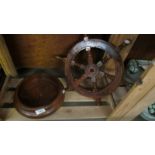 A wooden ship's wheel and a wooden bowl.