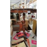 A mahogany pie crust edge tripod occasional table.