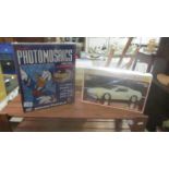 A Revell A/24 Nissan model kit and a Disney Donald photomosaic, both unopened.