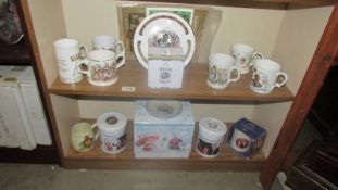 Two shelves of Royal commemorative ware.