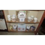 Two shelves of Royal commemorative ware.