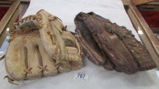 Two vintage baseball mitten gloves by Spalding & Wilson.