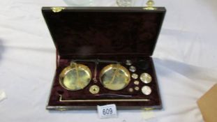 A cased set of brass scales.