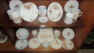 Two shelves of assorted Royal commemorative china.