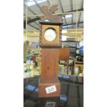 A pocket watch stand in the form of a Grandfather clock and a pocket watch.