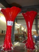 A pair of red over white glass vases