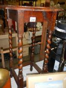 A 1930's oak side table with barley twist legs,